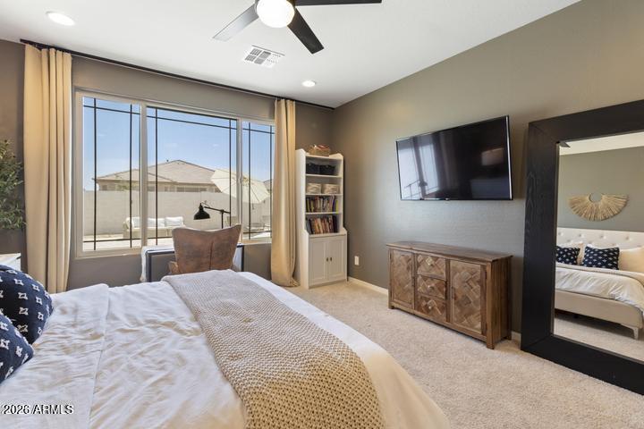 22849 East Marsh Road Queen Creek, AZ 85142 - Photo 17 of 38 a bedroom with a large bed and a flat tv screen
