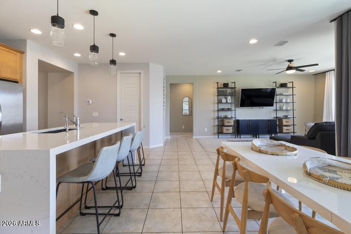 22849 East Marsh Road Queen Creek, AZ 85142 - Photo 9 of 38 a large kitchen with kitchen island a table and chairs in it