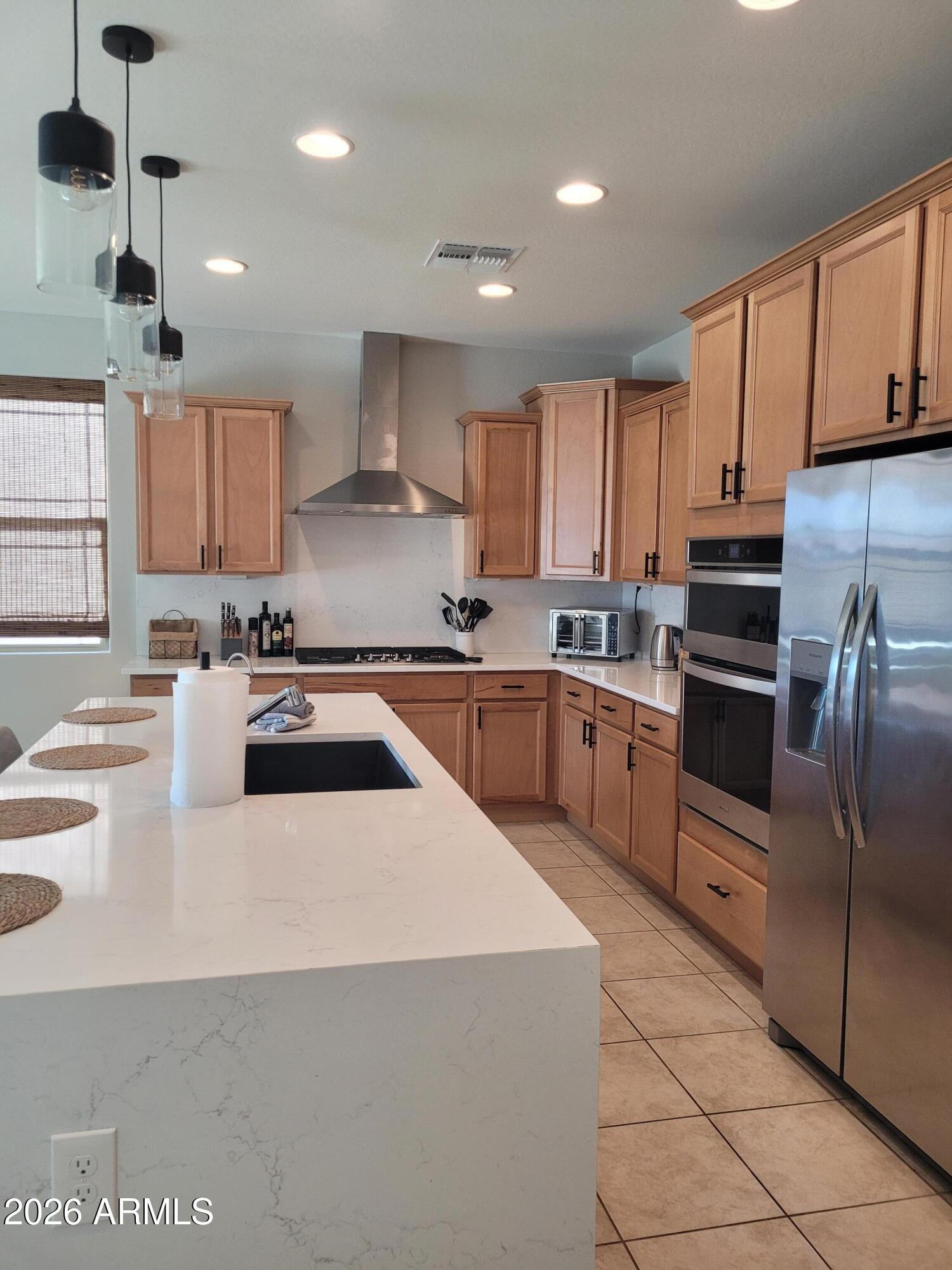 22849 East Marsh Road Queen Creek, AZ 85142 - Photo 10 of 38 a kitchen with granite countertop a sink stainless steel appliances and cabinets