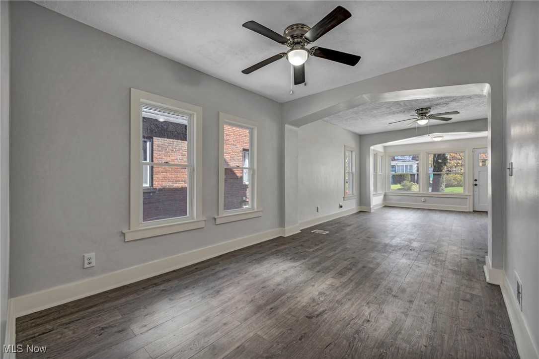 3239 Sycamore Road Cleveland, OH 44118 - Photo 28 of 49 Unfurnished room with ceiling fan, a textured ceiling, visible vents, baseboards, and dark wood-style floors