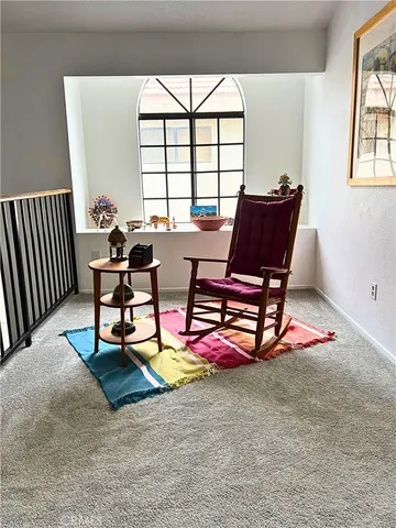 a dining room with furniture and a floor to ceiling window