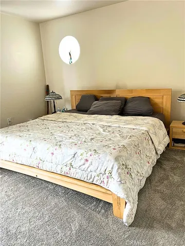 a bedroom with bed and window