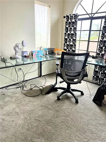 a room with table chairs and window