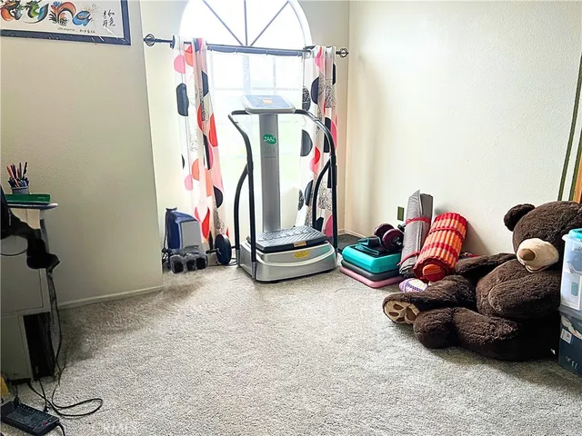 a backyard of a house with gym equipment