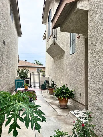 a view of a balcony with chairs potted plants