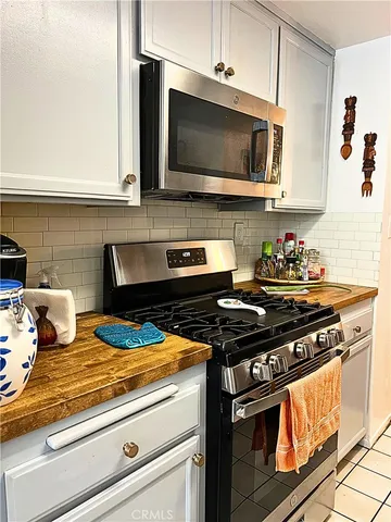 a kitchen with stainless steel appliances granite countertop a stove and a microwave