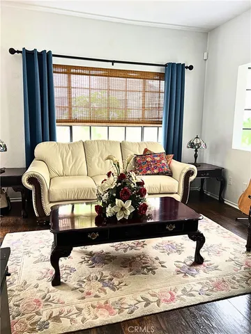 a living room with furniture window and wooden floor