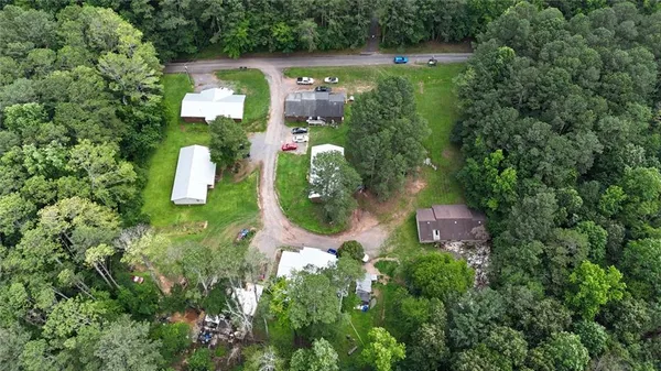 an aerial view of a house with outdoor space and lake view