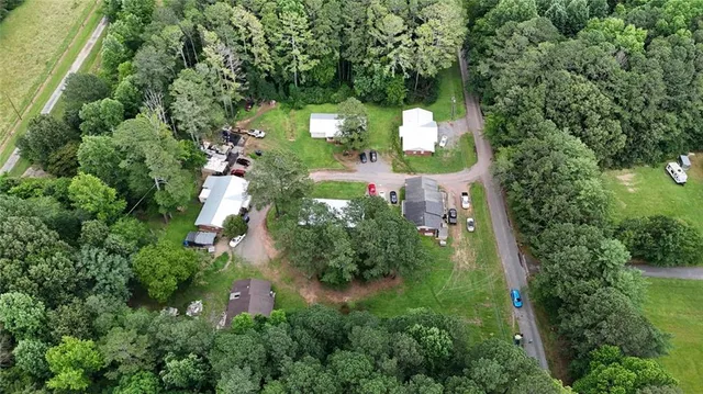 an aerial view of a house with a yard and trees