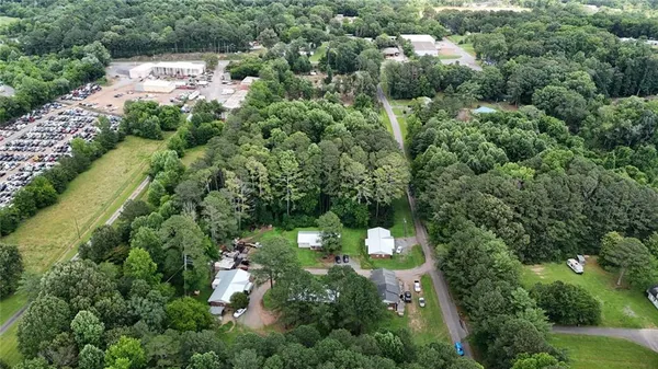 an aerial view of residential houses with outdoor space and trees