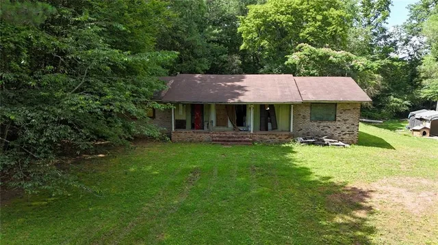 an aerial view of a house with garden space and parked car