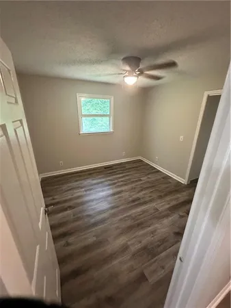 a view of a room with wooden floor