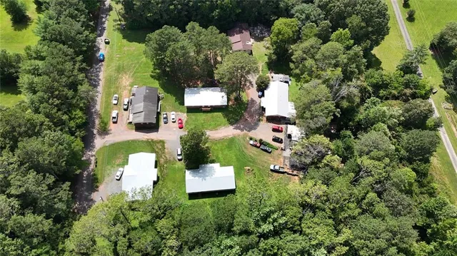 an aerial view of a house with a yard and swimming pool