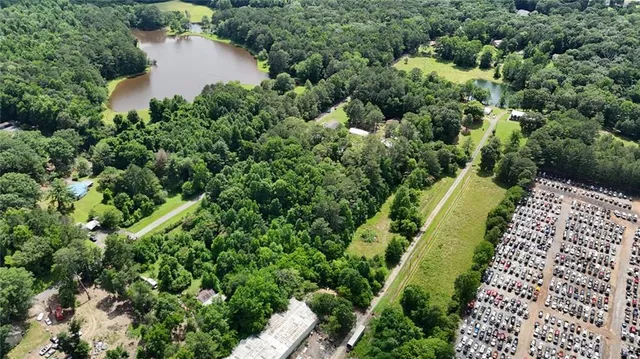 an aerial view of a house with a yard and lake view