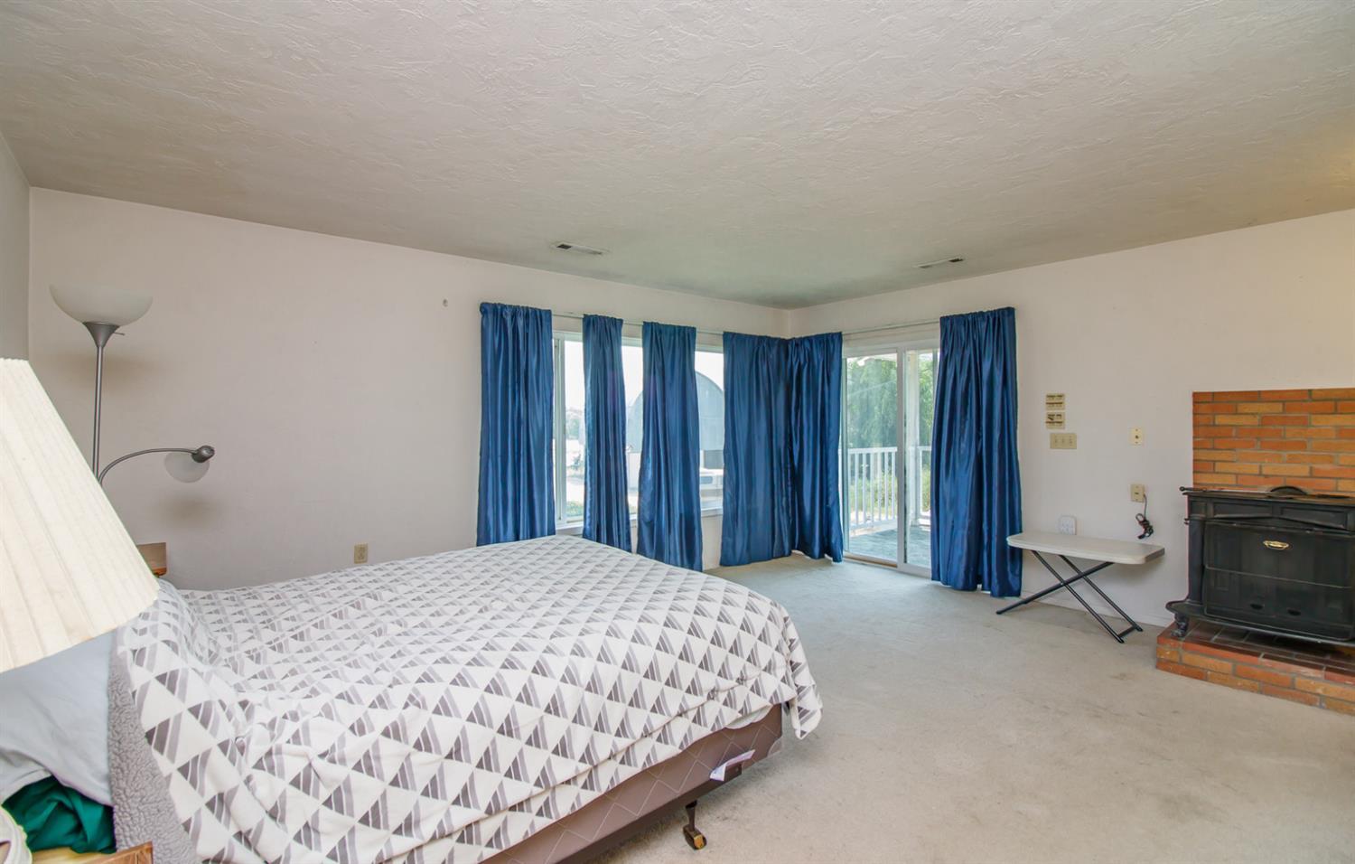 1039 West Valley View Road Ashland, OR 97520 - Photo 13 of 32 a bedroom with a bed and tv