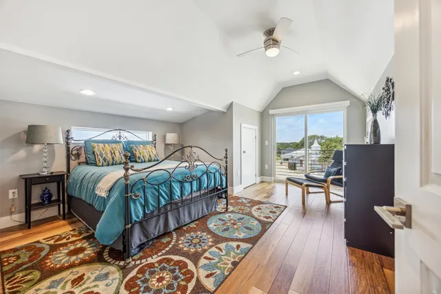 a bedroom with furniture and a wooden floor