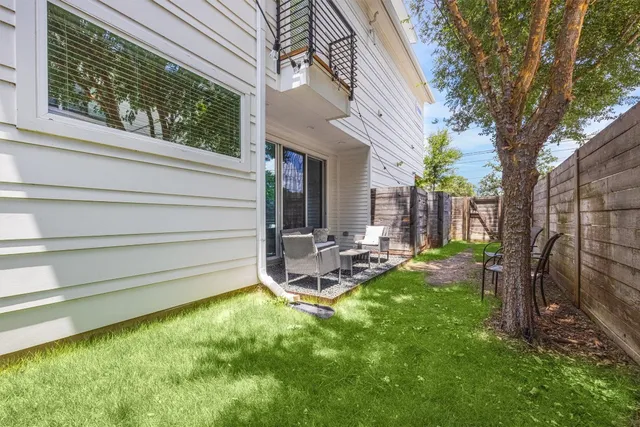 a view of a house with backyard and sitting area
