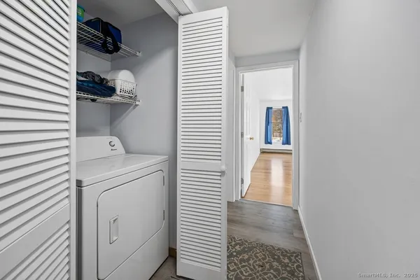 a hallway with a washer and dryer