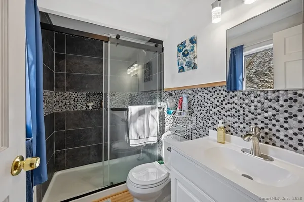 a bathroom with a sink toilet and shower