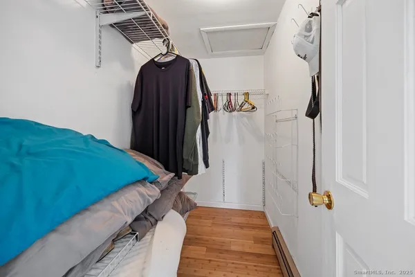 a view of walk in closet with clothes and shoes