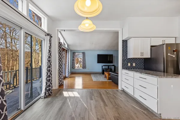 a kitchen with granite countertop a stove a sink and a refrigerator