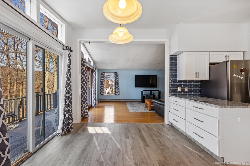 124 East Street Wolcott, CT 06716 - Photo 2 of 39 a kitchen with granite countertop a stove a sink and a refrigerator
