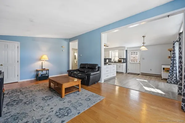 a living room with furniture and wooden floor