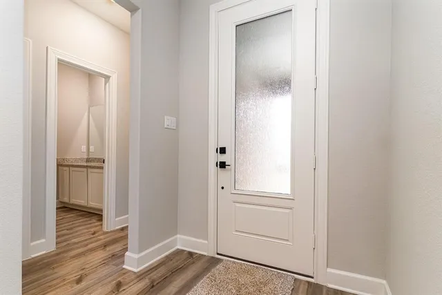 a view of kitchen with refrigerator microwave and stove