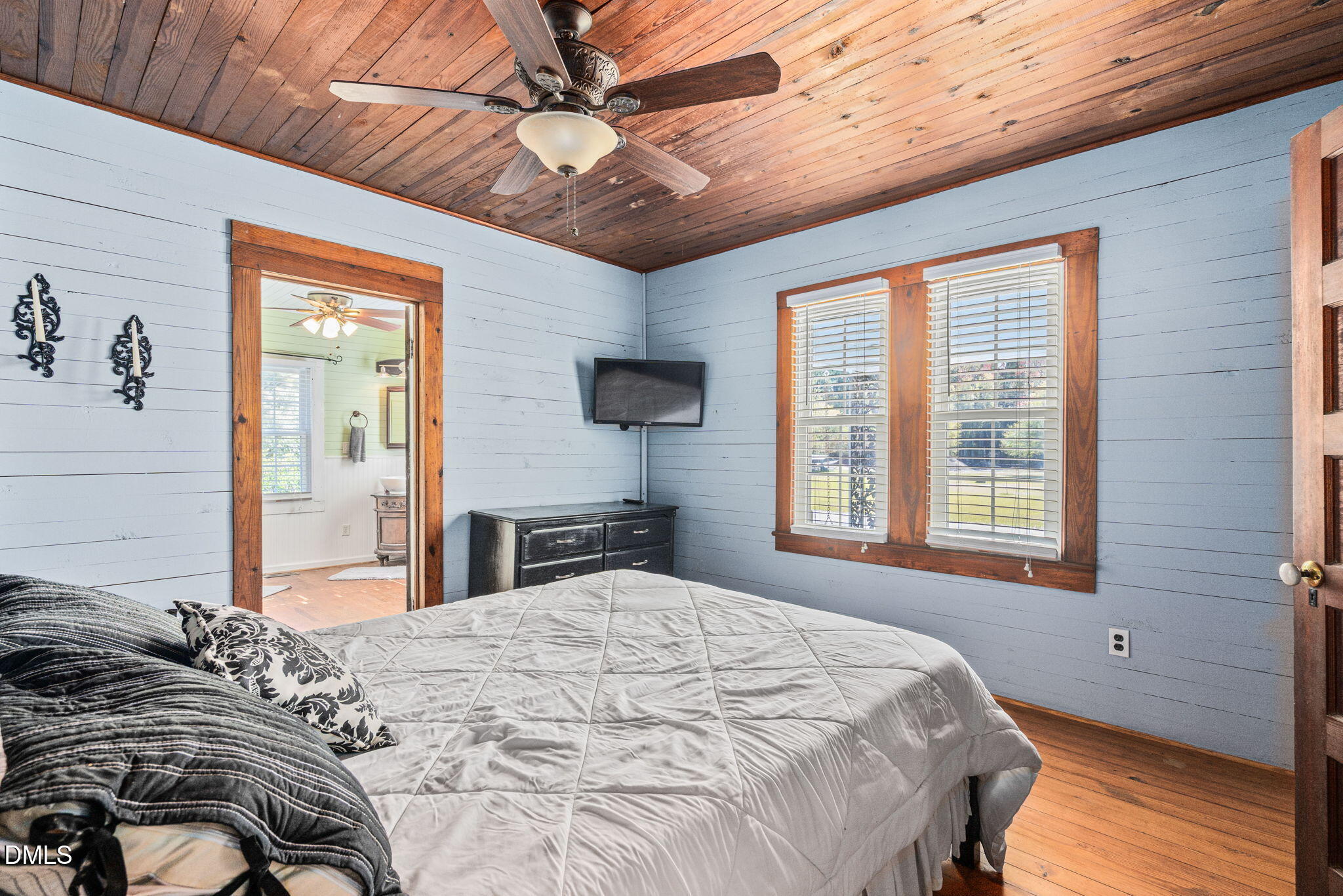 125 Branch Chapel Church Road Selma, NC 27576 - Photo 17 of 39 a bedroom with a large bed and a tv