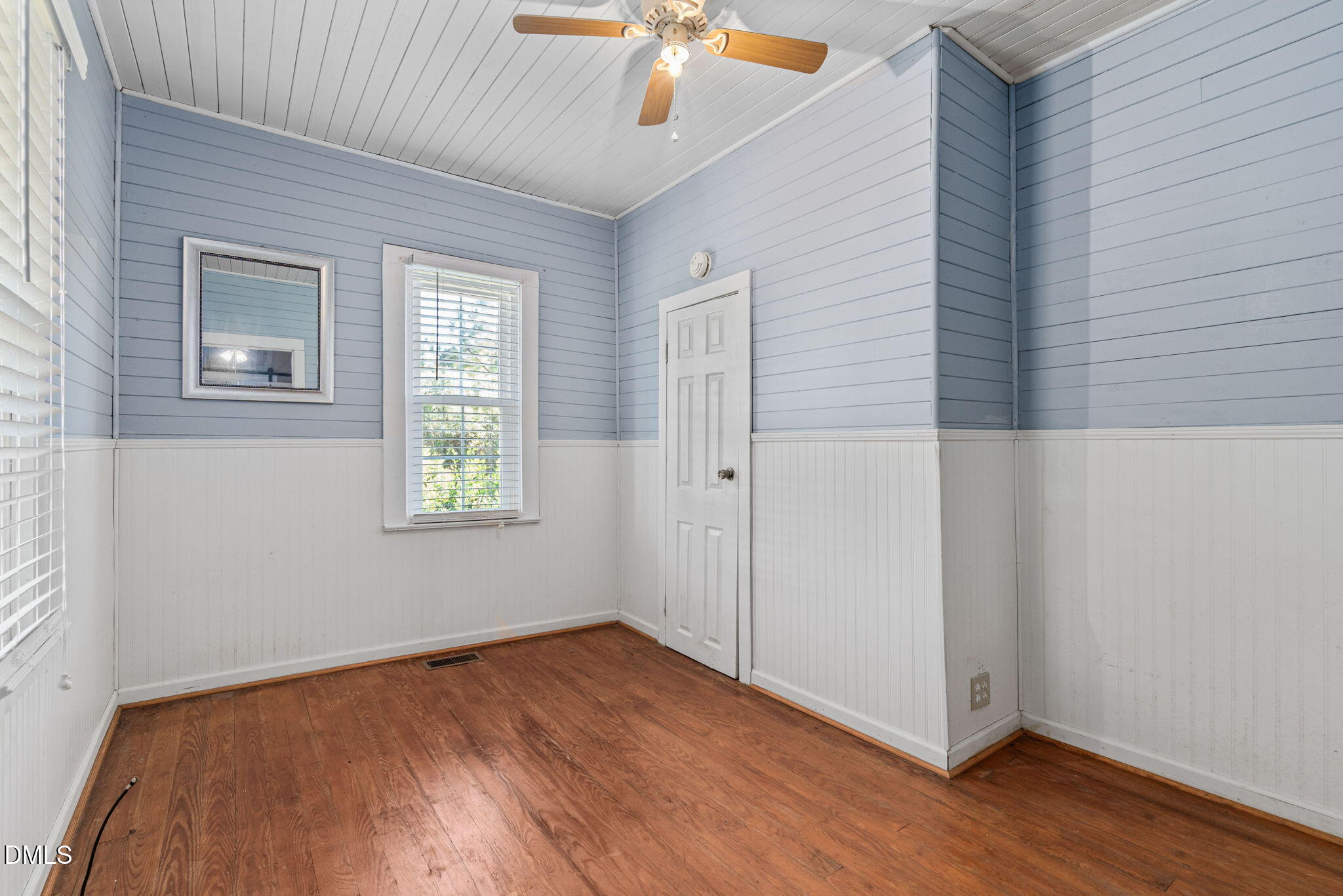 125 Branch Chapel Church Road Selma, NC 27576 - Photo 24 of 39 an empty room with wooden floor chandelier fan and windows