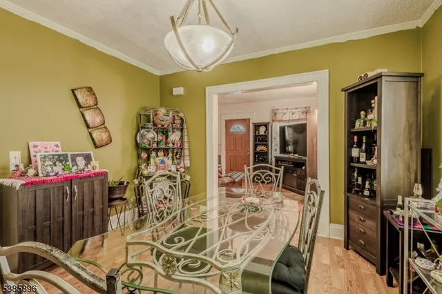a view of a dining room with furniture wooden floor and a chandelier