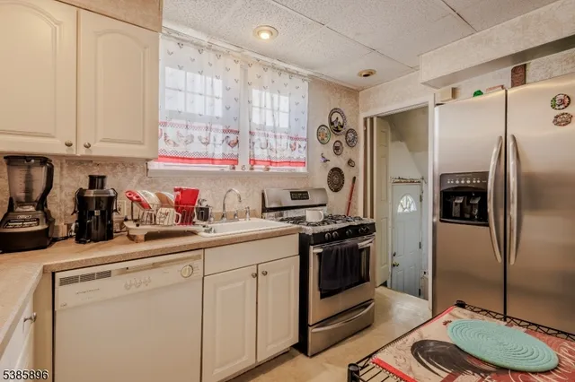 a kitchen with a sink appliances and cabinets