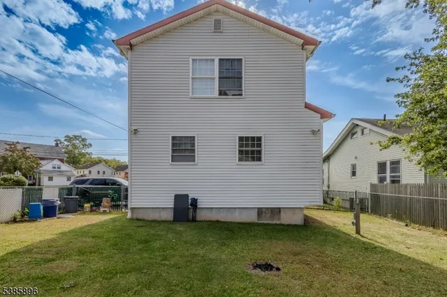 a view of a house with a backyard
