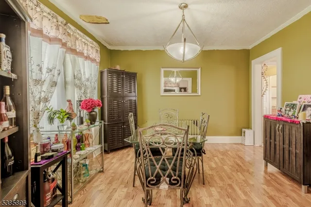 a view of a dining room with furniture and a chandelier