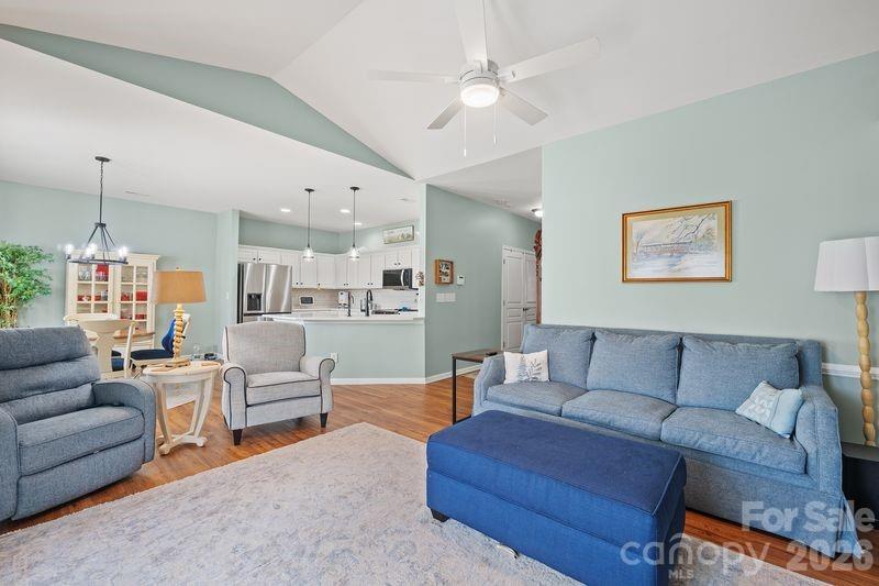 16515 Amberside Road East Cornelius, NC 28031 - Photo 19 of 35 a living room with furniture ceiling fan and a rug