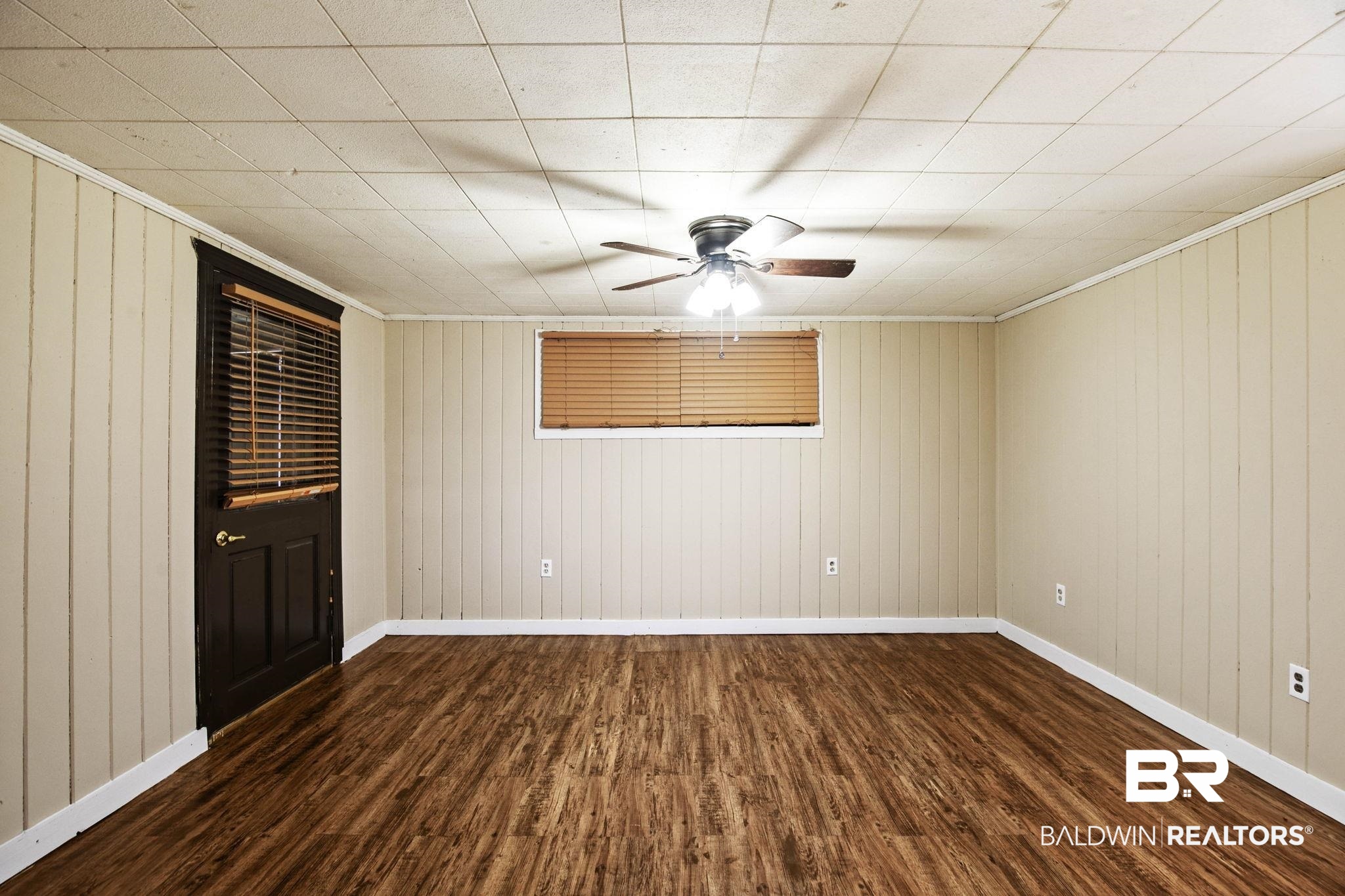 23240 County Road 47 Perdido, AL 36562 - Photo 11 of 29 Spare room featuring dark wood-style floors, wooden walls, ceiling fan, and crown molding