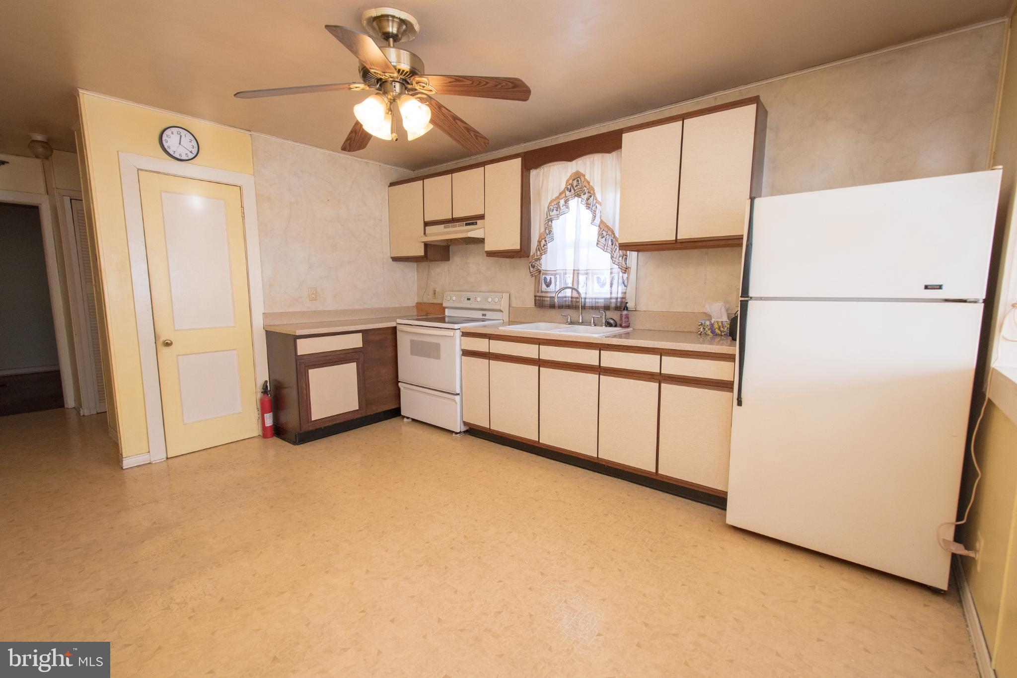 4022 West 7th Street Trainer, PA 19061 - Photo 17 of 49 a kitchen with stainless steel appliances a refrigerator sink and white cabinets