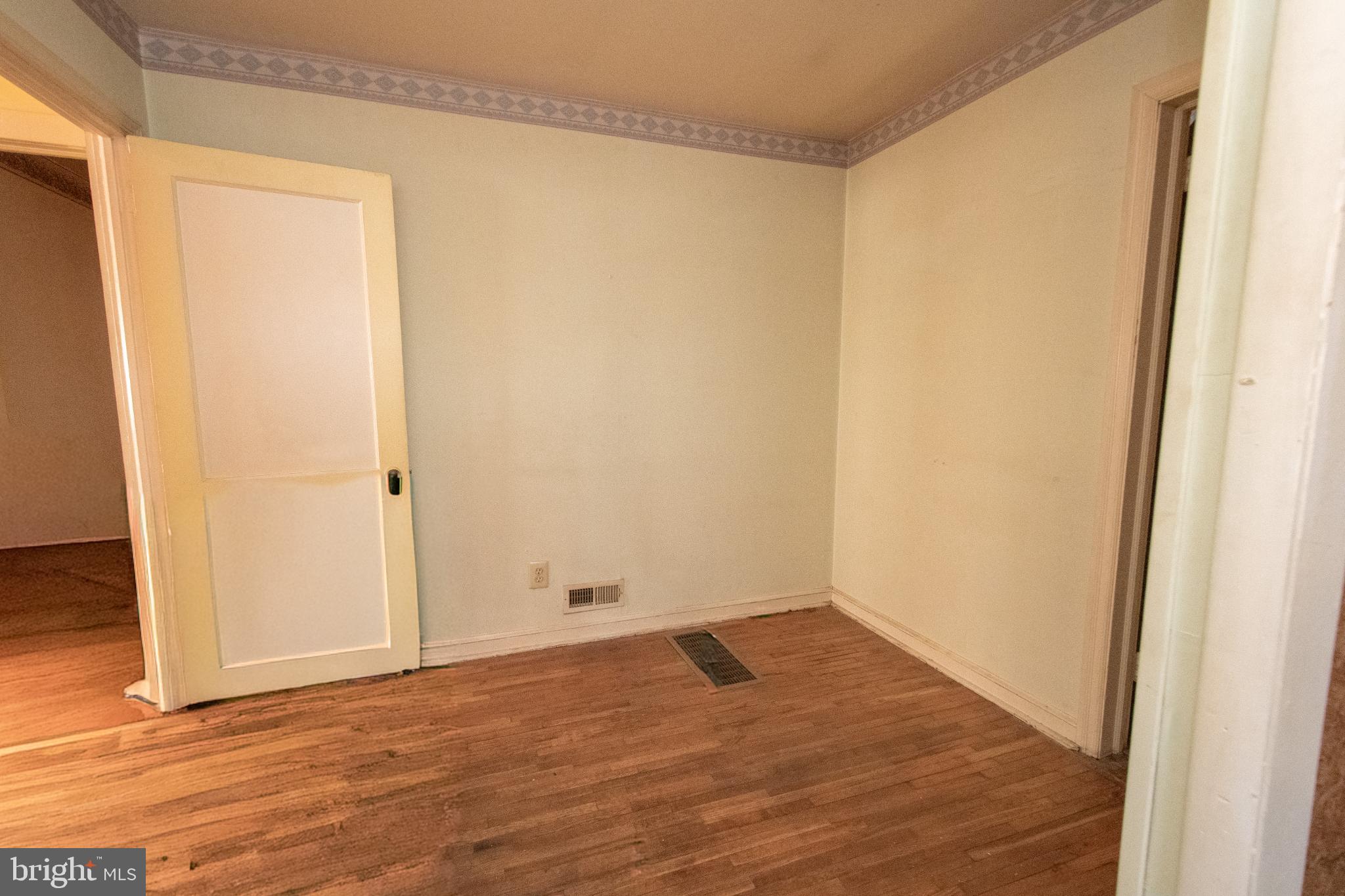 4022 West 7th Street Trainer, PA 19061 - Photo 22 of 49 an empty room with wooden floor and a window