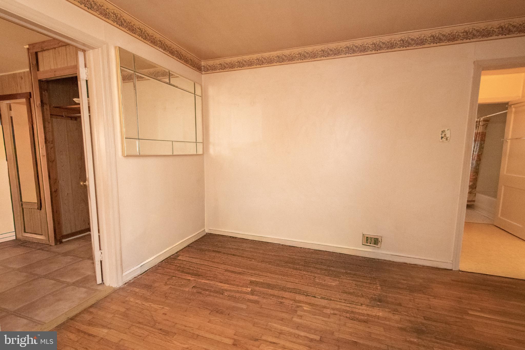 4022 West 7th Street Trainer, PA 19061 - Photo 39 of 49 a view of an empty room with wooden floor and a window