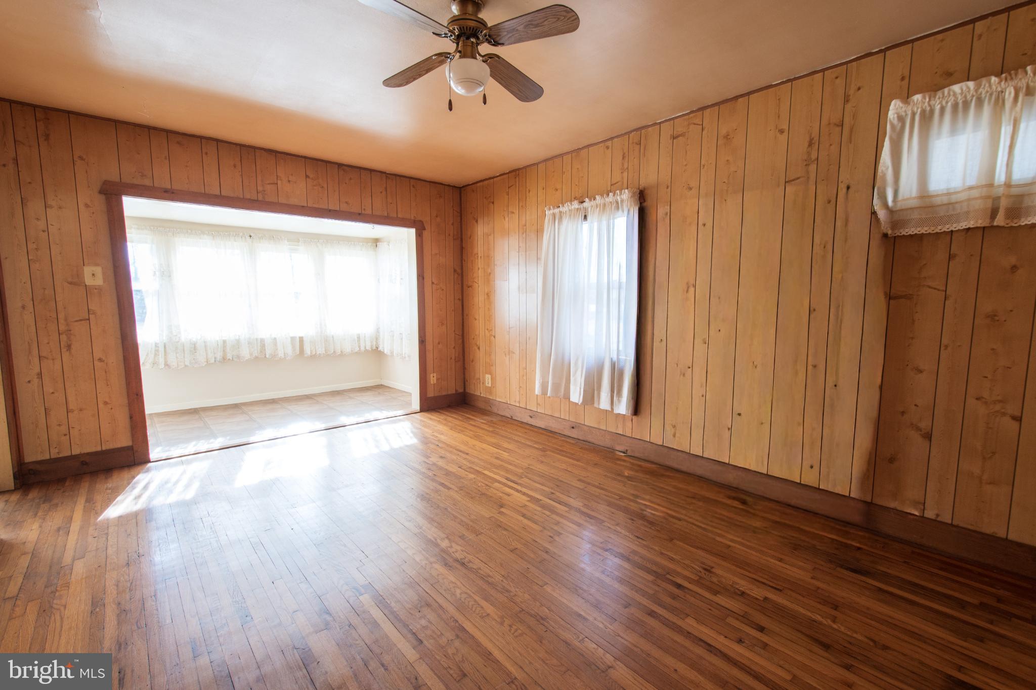4022 West 7th Street Trainer, PA 19061 - Photo 8 of 49 an empty room with wooden floor fan and windows