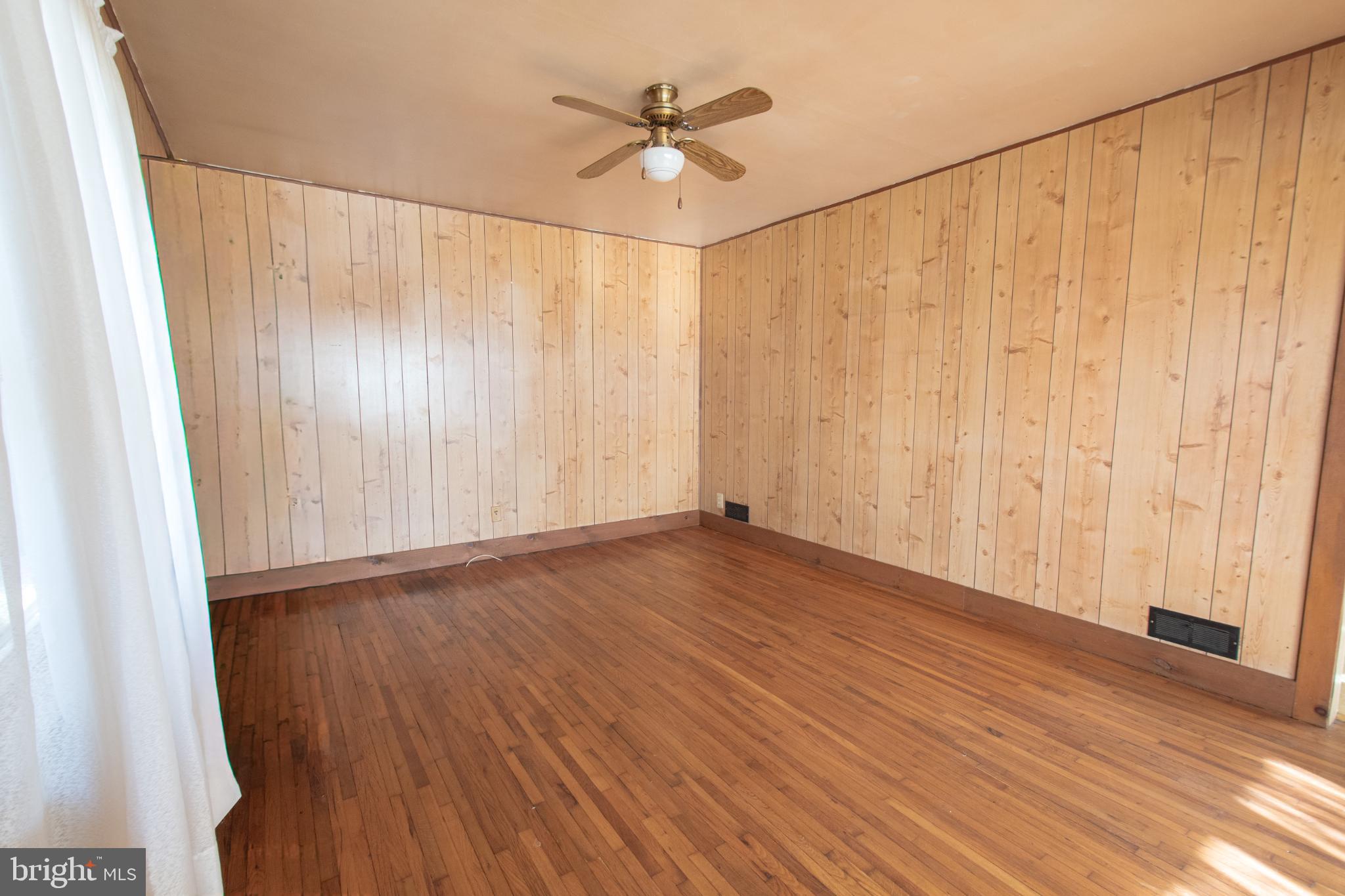 4022 West 7th Street Trainer, PA 19061 - Photo 10 of 49 an empty room with wooden floor fan and windows