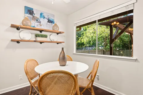 a dining room with furniture window and outside view