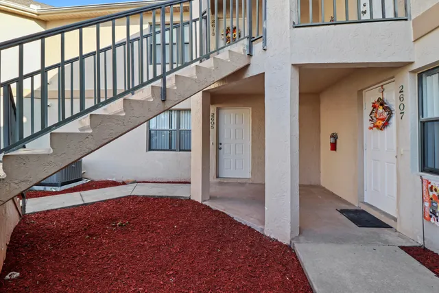 a view of a sign board with a bunch of plants