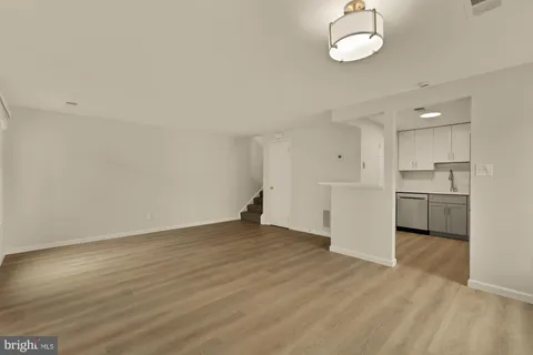 a view of a kitchen with a sink and a refrigerator