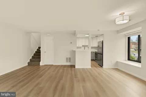 a view of a kitchen with wooden floor and a kitchen