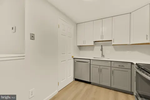 a kitchen with white cabinets