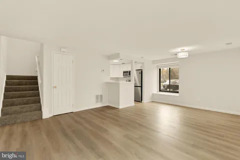 a view of hallway with couch and a table