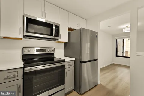 a kitchen with a refrigerator stove and microwave