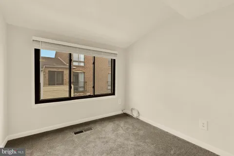 a view of a hallway with a chandelier fan