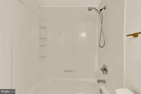 a bedroom with a bed and a potted plant